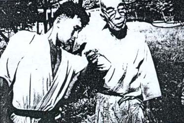 Takamatsu Sensei demonstrating Musha dori on Hatsumi Sensei; part of the Kihon Happo